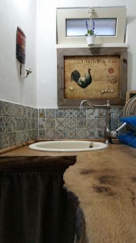 a bathroom with a sink with a wooden counter top at La dimora di zio Nino in Martina Franca