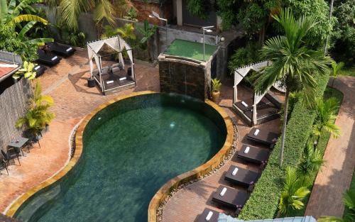 an overhead view of a swimming pool with chairs and a golf ball at Central Indochine d'Angkor Hotel in Siem Reap
