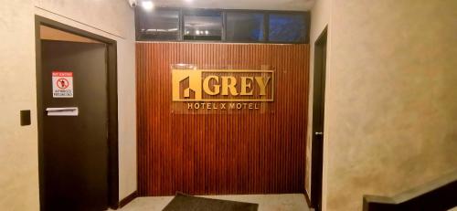 a sign on the wall of a hotel lobby at Dancenter Airport Hotel - Grey Hotel in Pampang