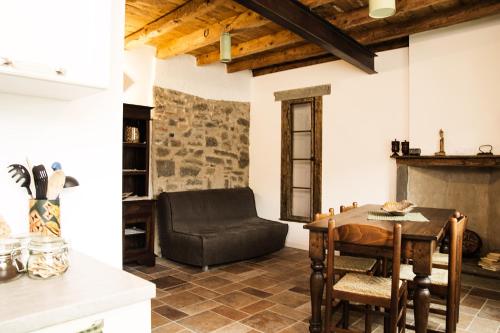 a living room with a table and a chair at Casa Artisti del Sole in Paratico