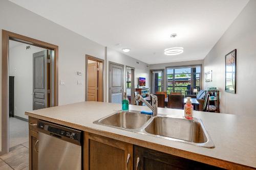 a kitchen with a sink and a counter at Upper Floor w Courtyard View 550 in Kelowna