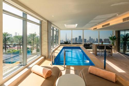 a house with a swimming pool with a view of the city at Al Bandar Rotana – Dubai Creek in Dubai