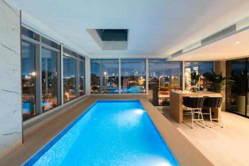 a swimming pool in a house with a view of the city at Al Bandar Rotana – Dubai Creek in Dubai