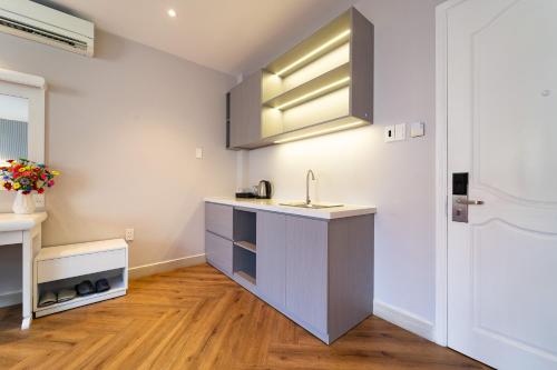 a kitchen with a sink and a counter at Golden Suites Saigon in Ho Chi Minh City