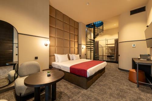 a hotel room with a bed and a desk at NOBO - Hotel in old Tbilisi in Tbilisi City