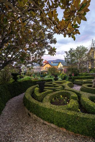 a garden with a maze of bushes and trees at Corinda Contemporary in Hobart
