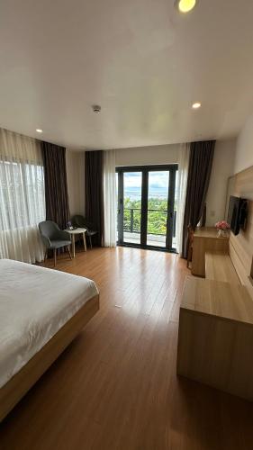 a hotel room with a bed and a living room at Rosso Sky Villa Phu Quoc in Phú Quốc