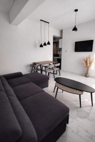 a living room with a couch and tables at White Rocks Meteora in Kalabaka