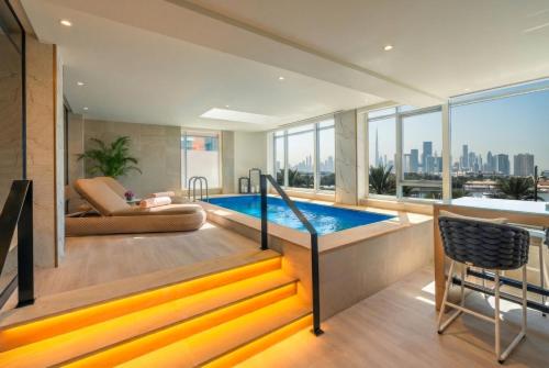 a living room with a swimming pool and a couch at Al Bandar Arjaan by Rotana – Dubai Creek in Dubai