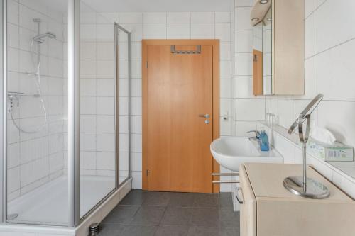 a bathroom with a shower and a tub and a sink at Ferienwohnung Regentalblick in Miltach