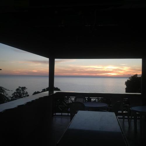 a view of the ocean at sunset from a balcony at Boutique B&B at Stone Village in Bluefields