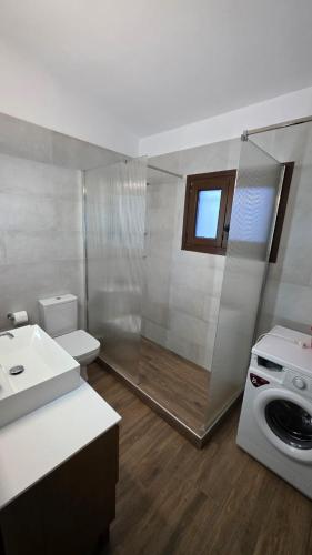 a bathroom with a shower and a sink and a toilet at Potokaki Coastal Haven in Potokáki