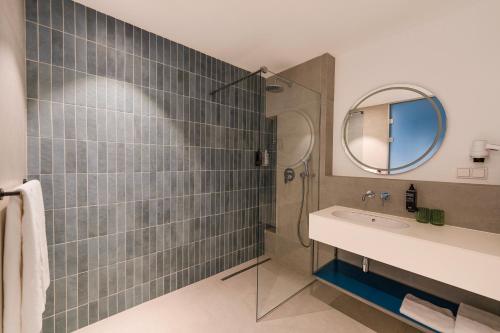 a bathroom with a sink and a mirror at ibis Styles Chisinau in Chişinău