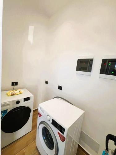 une machine à laver et un lave-linge dans une pièce dans l'établissement Vila KAM, à Vlorë