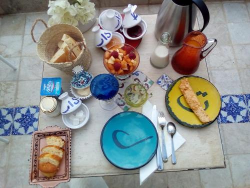 a table with plates of food and desserts on it at Dar R'Bat, Maison d'Hôtes de charme in Nabeul