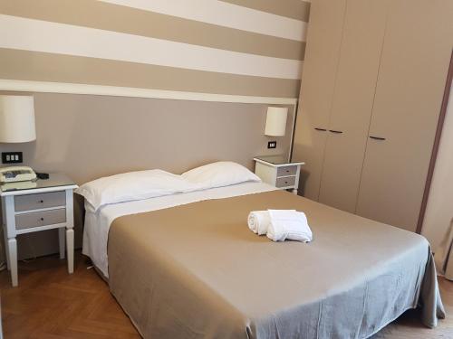 a hotel room with two beds and a towel on the bed at Park Hotel in Montecatini Terme