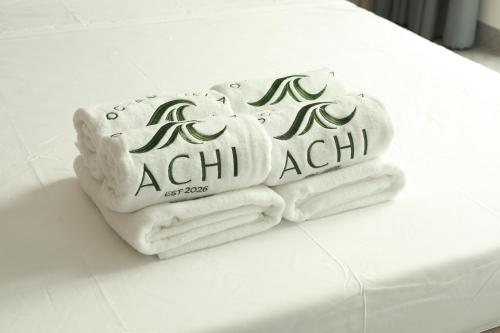 a pile of towels sitting on a table at Achi Ocean Villa in Cửa Lô