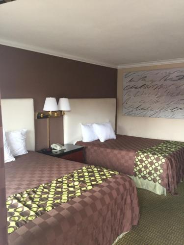a hotel room with two beds in a room at American Inn Stockton in Stockton