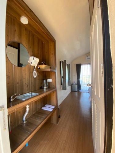 a bathroom with a sink and a mirror at Olympus khaoyai in Ban Nong Makha