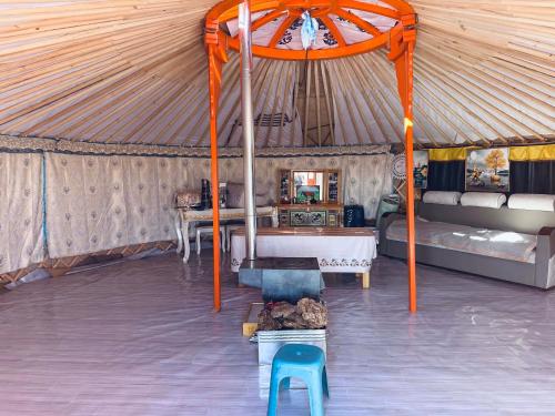 a room with a tent with a bed and a chair at Mongolian Nomadic Herders in Dörgön