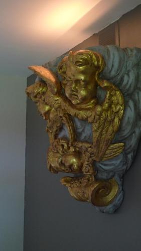 a gold statue of a person riding a fish at La Bonne Auberge - Seine Panorama SAS in Vieux-Port