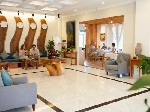 a group of people sitting in a lobby at Le Kree Downtown Hotel in Phnom Penh
