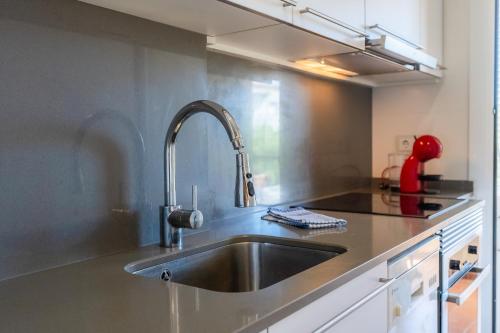 a kitchen with a stainless steel sink in a kitchen at Apartamento Serenity in Cunit