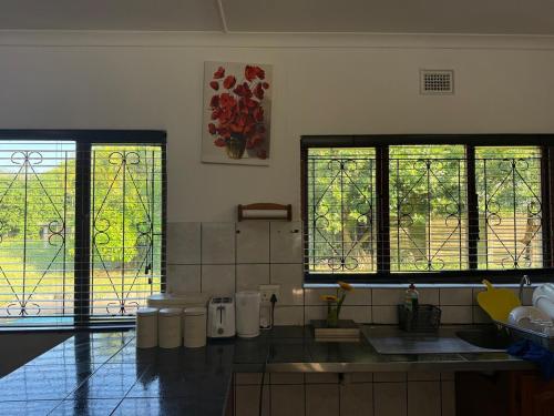 a kitchen with two large windows in a room at SeaBreeze Sanctuary in Richards Bay