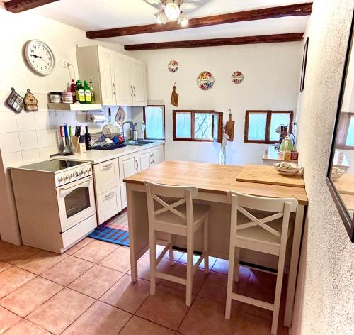 a kitchen with a table and some chairs in it at Casa del Sorriso in Costa