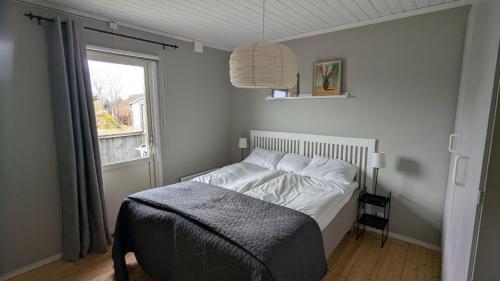 a bed in a bedroom with a window and a bedspread at Ebbas i Överboda in Överboda