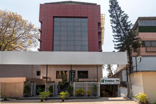 a building with a red and white building at Treebo Royal Empire in Chinchwad