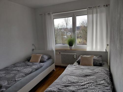 a bedroom with two beds and a window at Ferienwohnung Lorke in Thiersheim