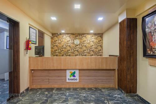 a lobby of a hospital with a sign on the wall at Treebo Royal Empire in Chinchwad