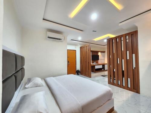 a bedroom with a large bed and wooden cabinets at hotel diana in Banda Aceh