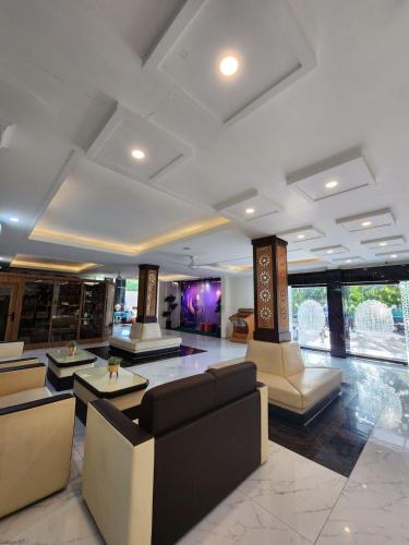 a lobby with couches and tables in a building at hotel diana in Banda Aceh