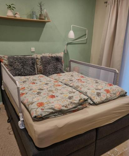 a bed with a quilt on it in a bedroom at Mediterran-Skandinavisch-2 in Burgthann