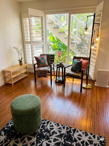 a living room with two chairs and a table at Walk to Dodger St Echo Park Modern 2BR with 1Gbps Fiber Parking in Los Angeles