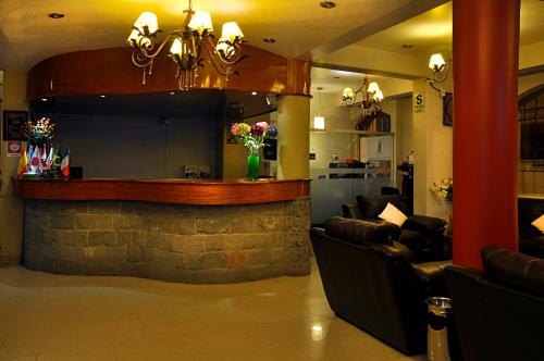 a bar in a restaurant with couches and a counter at Casona Plaza Hotel Puno in Puno