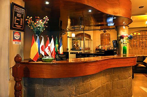 a bar with a bunch of different flags on it at Casona Plaza Hotel Puno in Puno