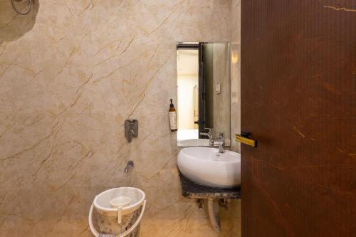 a bathroom with a sink and a mirror at Hotel Pravasa Stay, Dewas Naka in Indore