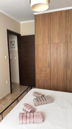 a bedroom with a bed with two towels on it at Anesis home in Gythio