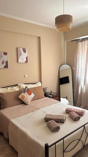 a bedroom with a large bed with two pillows on it at Anesis home in Gythio