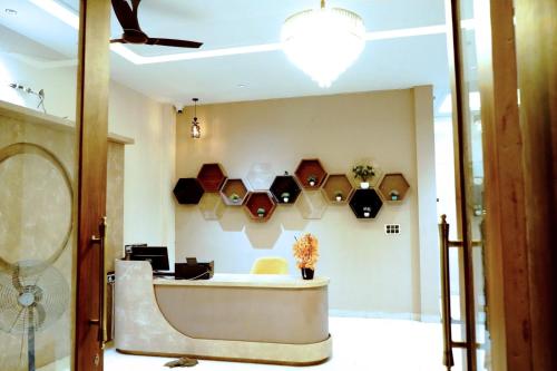 a lobby with a reception desk and a fan at Hotel Leena Inn in Jhālāwār