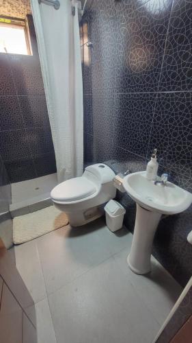a bathroom with a toilet and a sink at Llama House Cusco in Cusco