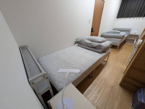 a hospital room with two beds in it at hostel 丹鶴 in Shingū