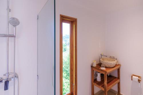 a bathroom with a shower and a mirror at Bukit Adi in Amed
