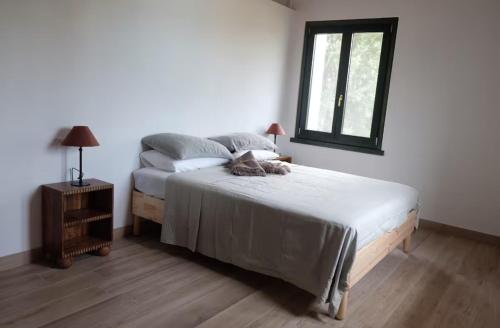 a bedroom with a bed and a window at Tenuta La Macina in Polpenazze del Garda