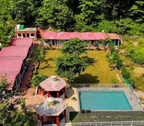 an aerial view of a resort with a swimming pool at Ekantam Riverside Resort in Bijni