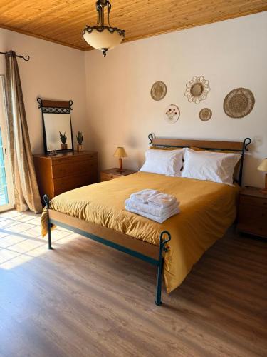 a bedroom with a large bed in a room at Casa de São Luís - Turismo Rural in Torre de Moncorvo