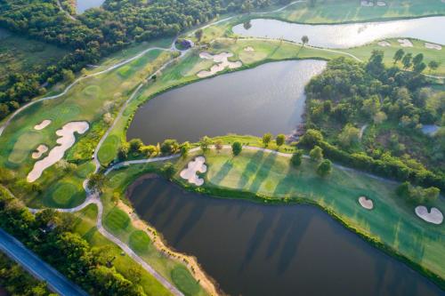 an overhead view of a golf course with two lakes at Springfield Village Golf & Spa in Cha Am